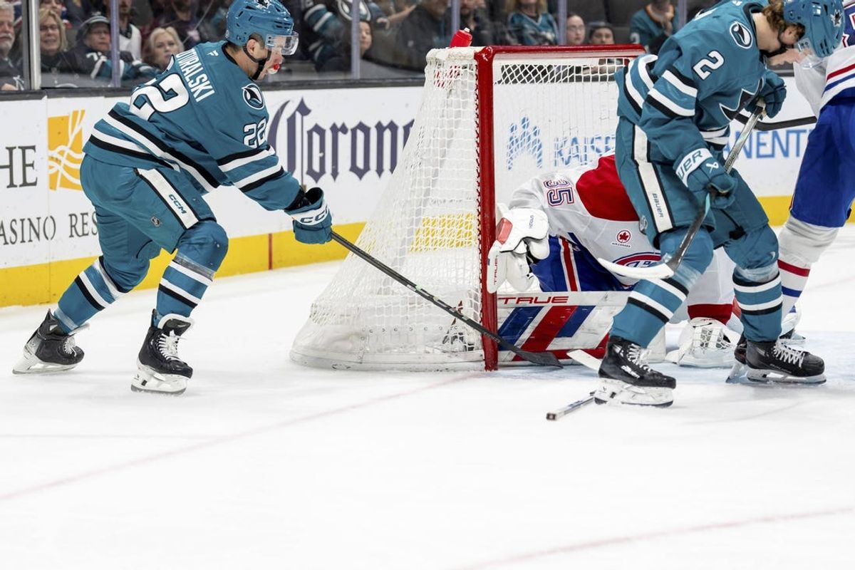 Feb 4, 2025; San Jose, California, USA;  San Jose Sharks center Andrew Poturalski (22) shots on goal against Montreal Canadiens goaltender Sam Montembeault (35) during the second period at SAP Center at San Jose. Mandatory Credit: Neville E. Guard-Imagn Images