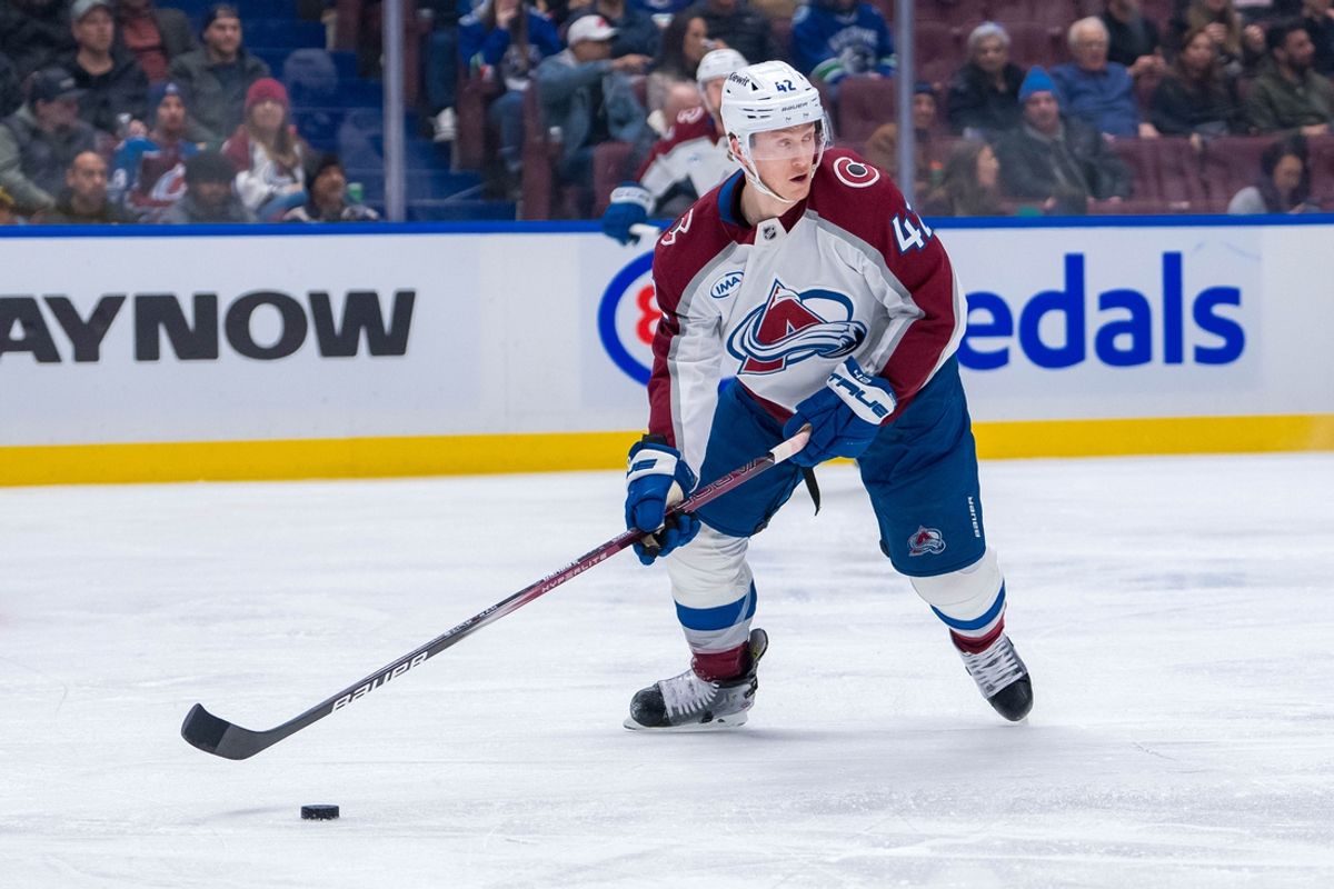 Feb 4, 2025; Vancouver, British Columbia, CAN; Colorado Avalanche defenseman Josh Manson (42) handles the puck against the Vancouver Canucks in the second period at Rogers Arena. Mandatory Credit: Bob Frid-Imagn Images