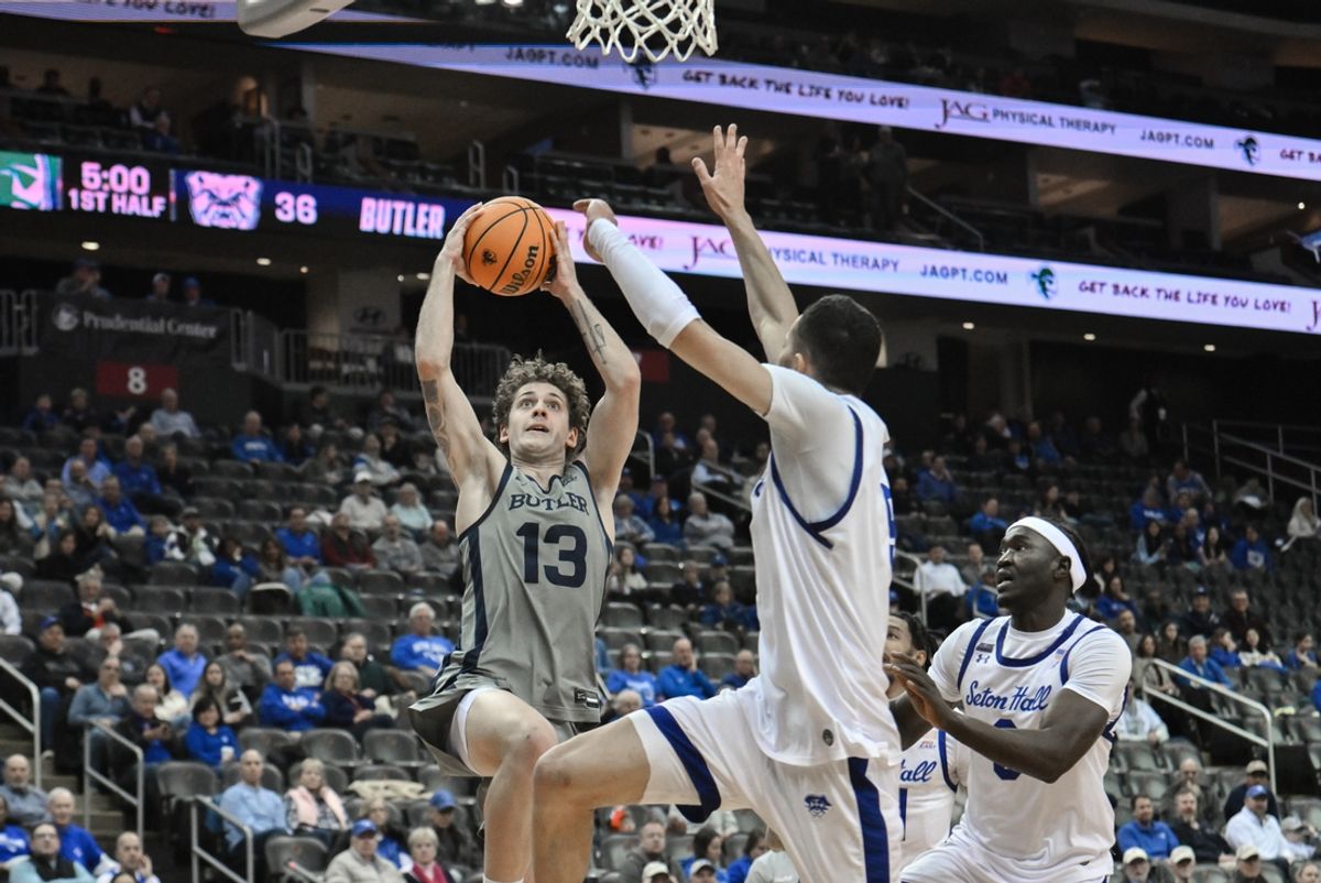 Feb 5, 2025; Newark, New Jersey, USA; Butler Bulldogs guard Finley Bizjack (13) drives to the basket while being defended by Seton Hall Pirates forward Yacine Toumi (9) during the first half at Prudential Center. Mandatory Credit: John Jones-Imagn Images