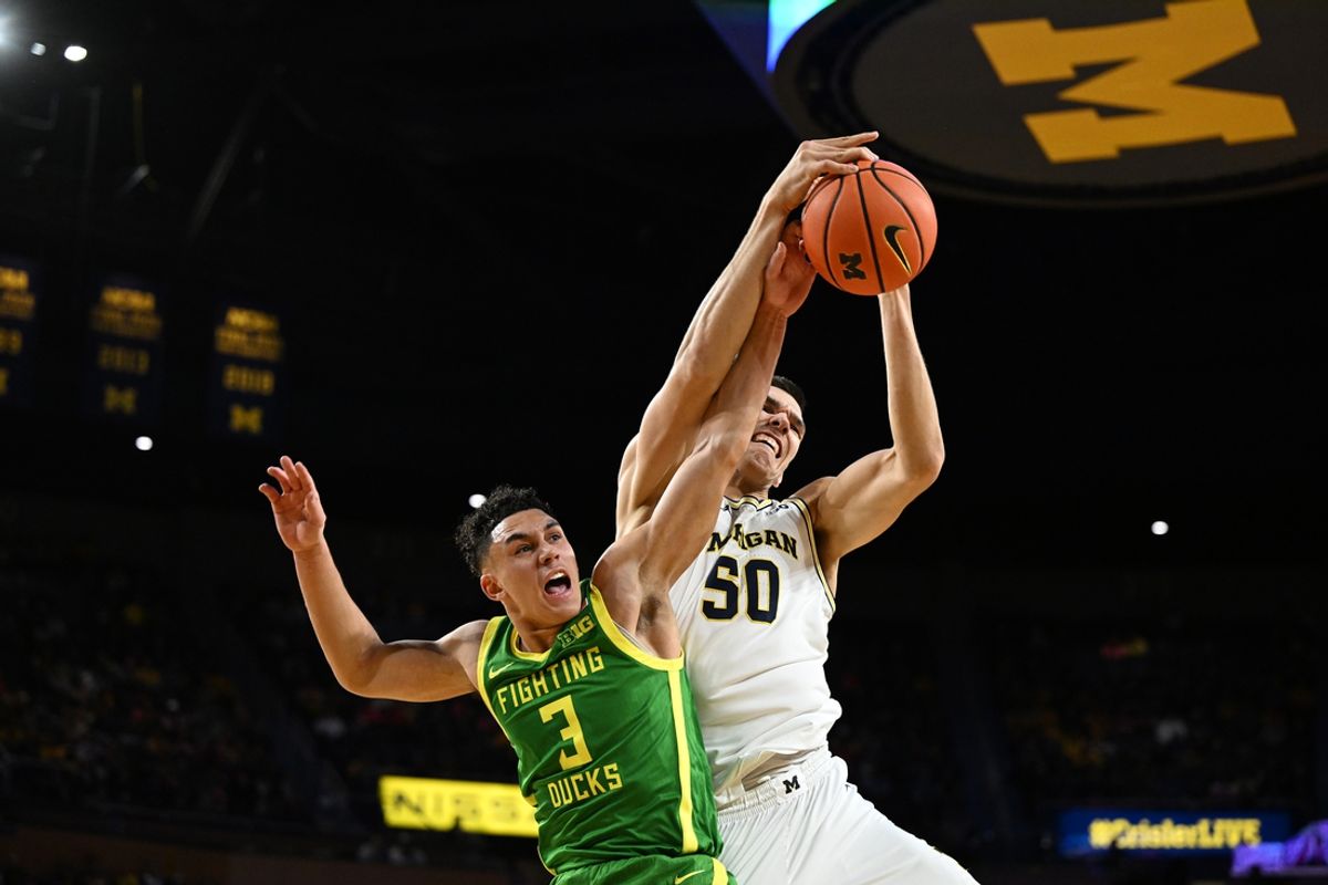 Feb 5, 2025; Ann Arbor, Michigan, USA;  Michigan Wolverines center Vladislav Goldin (50) and Oregon Ducks guard Jackson Shelstad (3) attempt to get a rebound in the first half at Crisler Center. Mandatory Credit: Lon Horwedel-Imagn Images