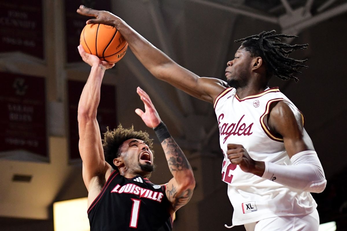 Feb 5, 2025; Chestnut Hill, Massachusetts, USA;  Boston College Eagles forward Jayden Hastings (22) blocks the shot of Louisville Cardinals guard J'Vonne Hadley (1) during the first half at Conte Forum. Mandatory Credit: Bob DeChiara-Imagn Images