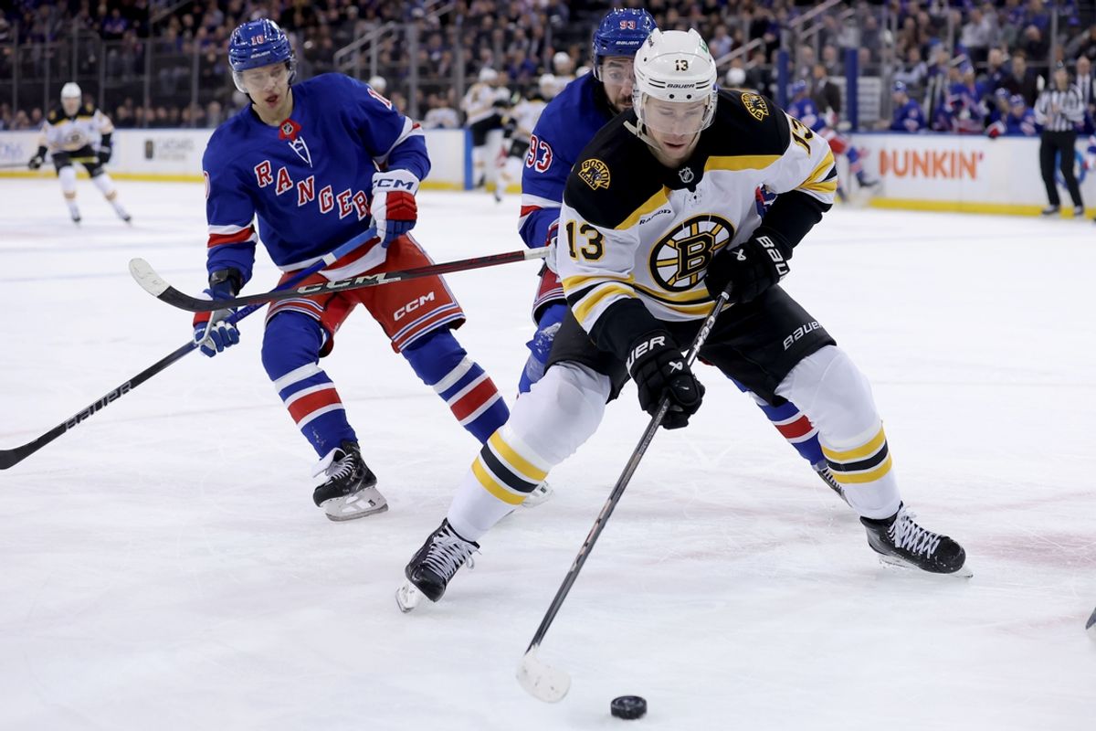 Feb 5, 2025; New York, New York, USA; Boston Bruins center Charlie Coyle (13) controls the puck against New York Rangers left wing Artemi Panarin (10) and center Mika Zibanejad (93) during the first period at Madison Square Garden. Mandatory Credit: Brad Penner-Imagn Images