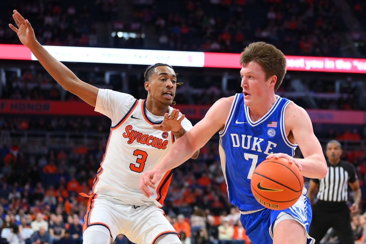 Feb 5, 2025; Syracuse, New York, USA; Duke Blue Devils guard Kon Knueppel (7) drives against Syracuse Orange guard Lucas Taylor (3) during the first half at the JMA Wireless Dome. Mandatory Credit: Rich Barnes-Imagn Images