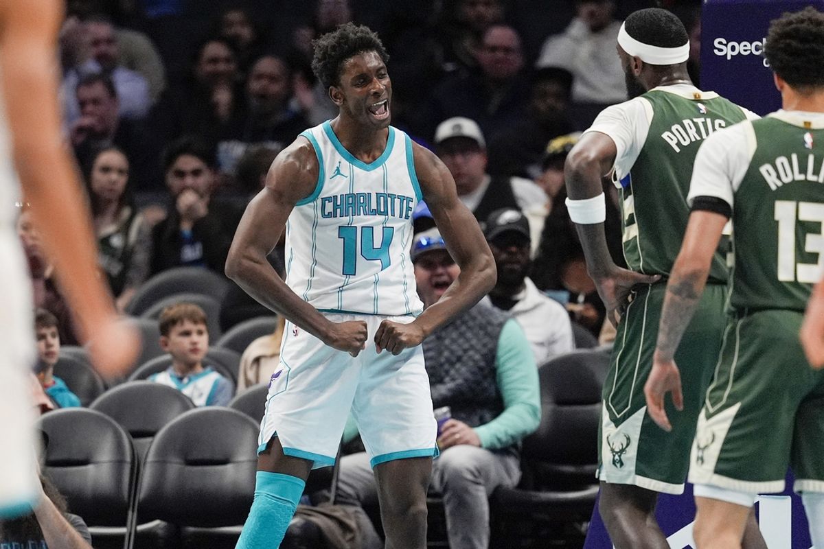 Feb 5, 2025; Charlotte, North Carolina, USA; Charlotte Hornets forward Moussa Diabate (14) reacts to his three point play against the Milwaukee Bucks during the second quarter at Spectrum Center. Mandatory Credit: Jim Dedmon-Imagn Images