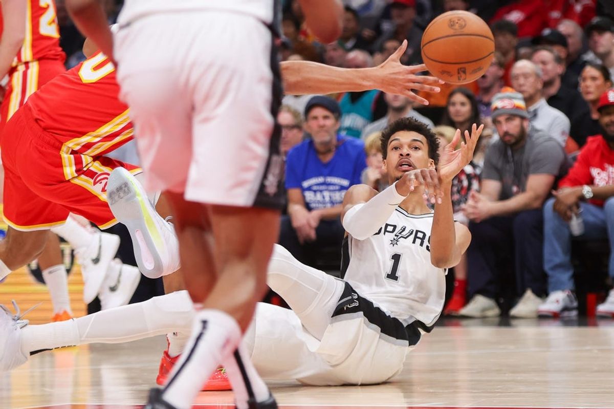 Feb 5, 2025; Atlanta, Georgia, USA; San Antonio Spurs center Victor Wembanyama (1) passes after controlling a loose ball against the Atlanta Hawks in the first quarter at State Farm Arena. Mandatory Credit: Brett Davis-Imagn Images