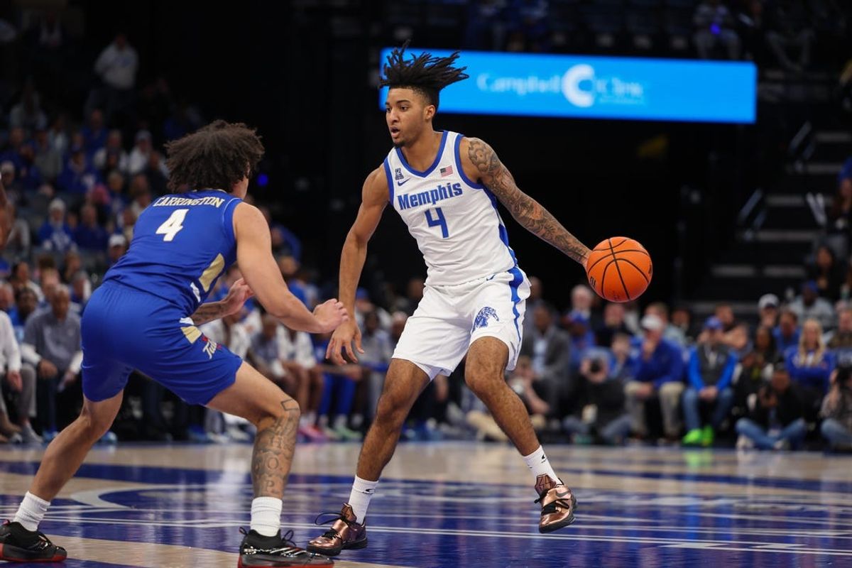 Feb 5, 2025; Memphis, Tennessee, USA; Memphis Tigers guard PJ Haggerty (4) handles the ball against Tulsa Golden Hurricane guard Braeden Carrington (4) during the first half at FedExForum. Mandatory Credit: Wesley Hale-Imagn Images