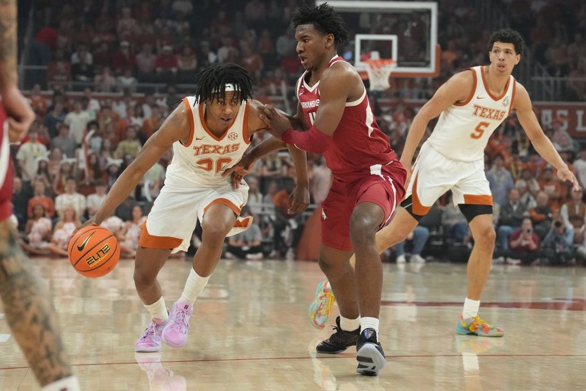 Feb 5, 2025; Austin, Texas, USA; Texas Longhorns guard Tre Johnson (20) drives to the basket while defended by Arkansas Razorbacks forward Adou Thiero (3) during the first half at Moody Center. Mandatory Credit: Scott Wachter-Imagn Images