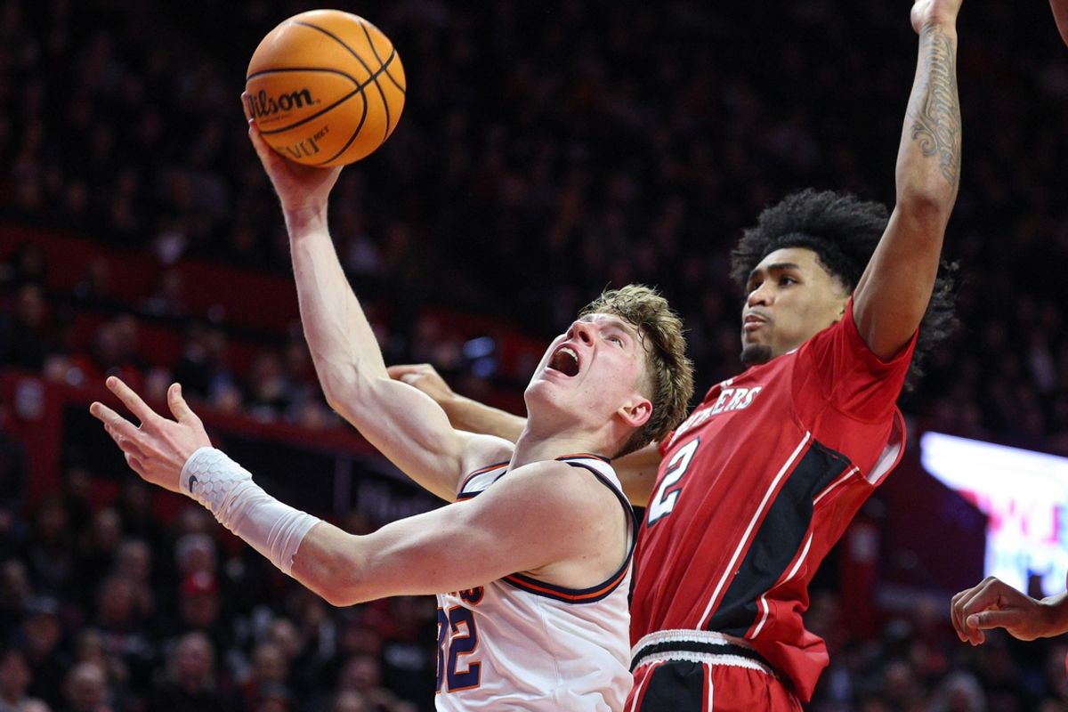 Feb 5, 2025; Piscataway, New Jersey, USA; Illinois Fighting Illini guard Kasparas Jakucionis (32) goes to the basket against Rutgers Scarlet Knights guard Dylan Harper (2) during the first half at Jersey Mike's Arena. Mandatory Credit: Vincent Carchietta-Imagn Images