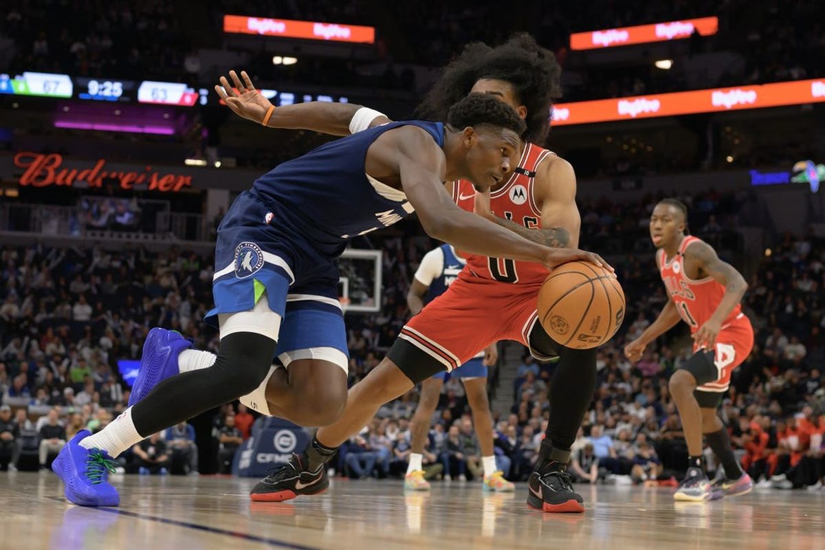 Feb 5, 2025; Minneapolis, Minnesota, USA; Minnesota Timberwolves guard Anthony Edwards (5) drives to the basket as Chicago Bulls guard Coby White (0) defends during the third quarter at Target Center. Mandatory Credit: Nick Wosika-Imagn Images