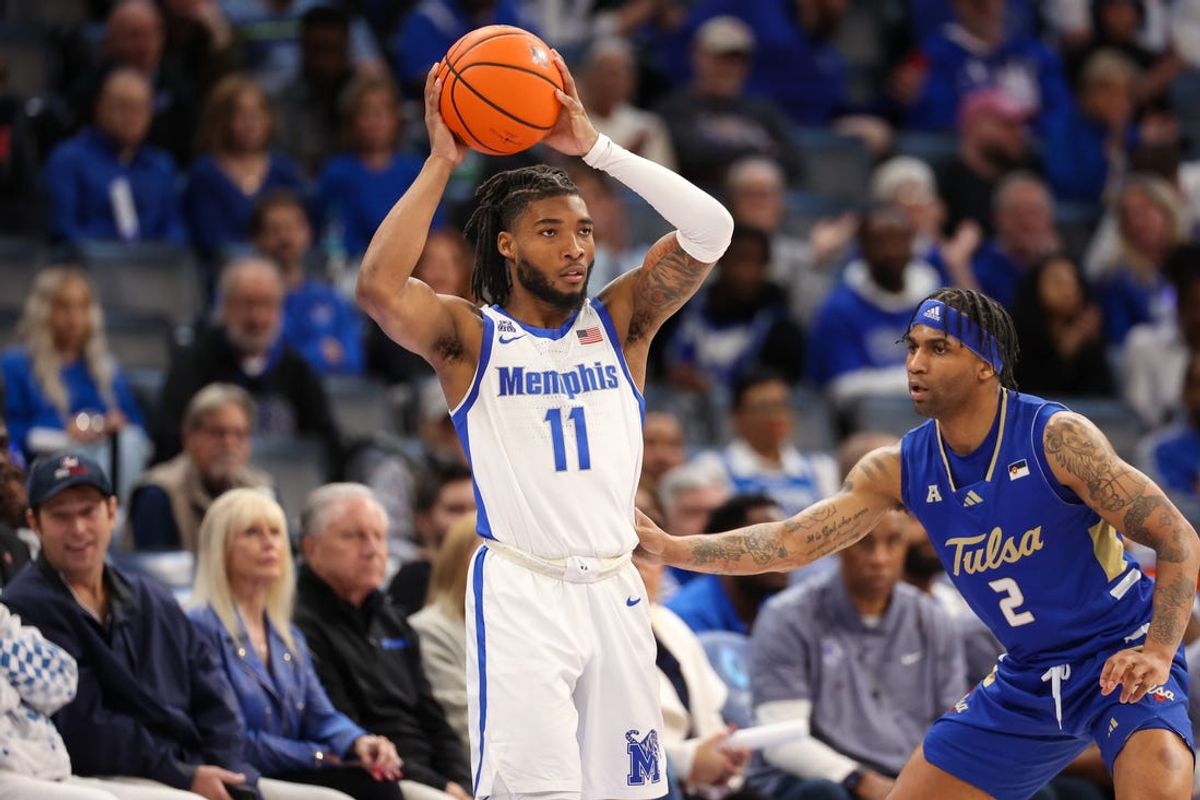 Feb 5, 2025; Memphis, Tennessee, USA; Memphis Tigers guard Tyrese Hunter (11) looks to pass the ball against Tulsa Golden Hurricane guard Dwon Odom (2) during the second half at FedExForum. Mandatory Credit: Wesley Hale-Imagn Images