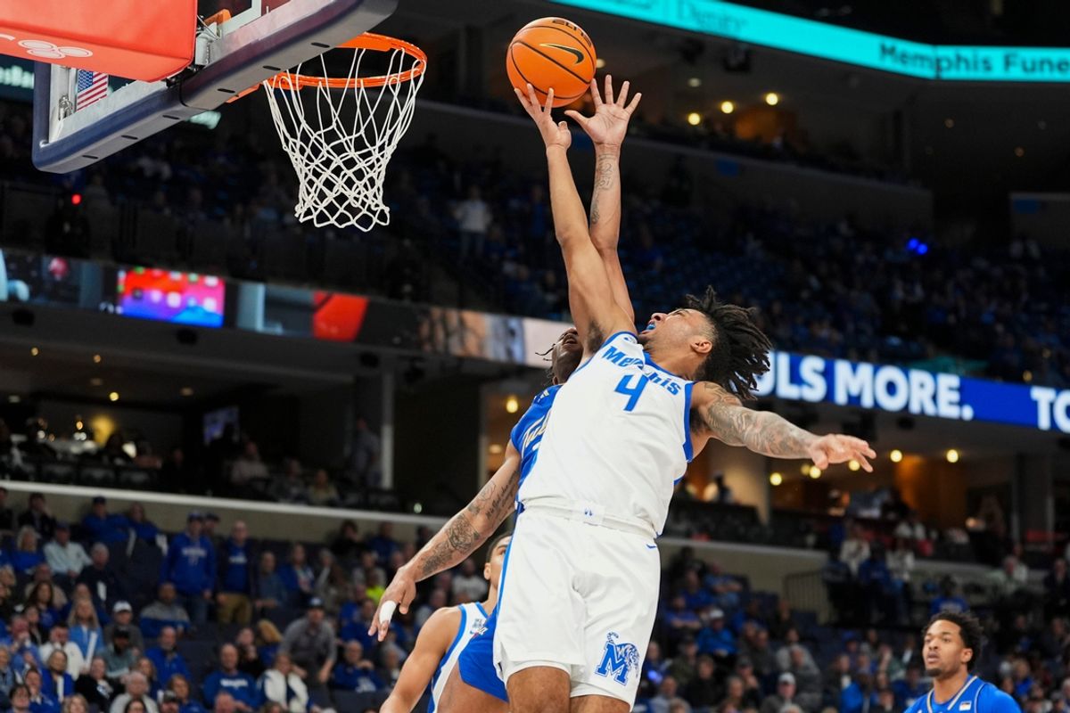 Memphis' PJ Haggerty (4) goes for a layup as Tulsa's Dwon Odom (2) tries to block him during the game between Tulsa University and the University of Memphis at FedExForum on Wednesday, February 5, 2025, in Memphis, Tenn.