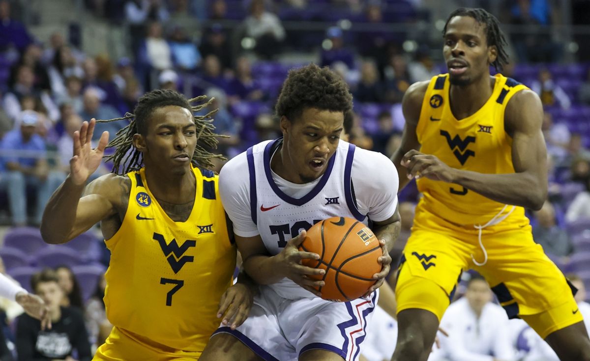 Feb 5, 2025; Fort Worth, Texas, USA;  TCU Horned Frogs guard Vasean Allette (3) controls the ball as West Virginia Mountaineers guard Javon Small (7) and West Virginia Mountaineers guard Toby Okani (5) defend during the second half at Ed and Rae Schollmaier Arena. Mandatory Credit: Kevin Jairaj-Imagn Images