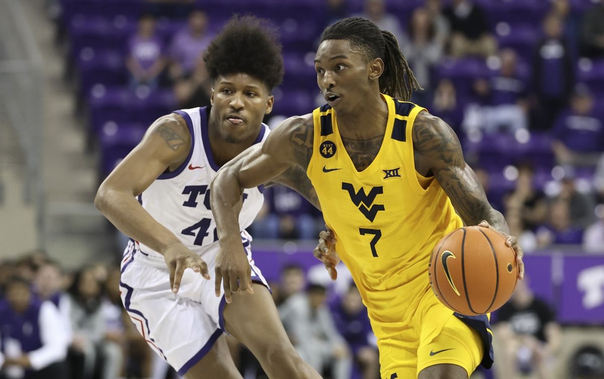 Feb 5, 2025; Fort Worth, Texas, USA;  West Virginia Mountaineers guard Javon Small (7) shoots the ball past TCU Horned Frogs guard Jace Posey (41) during the second half  at Ed and Rae Schollmaier Arena. Mandatory Credit: Kevin Jairaj-Imagn Images