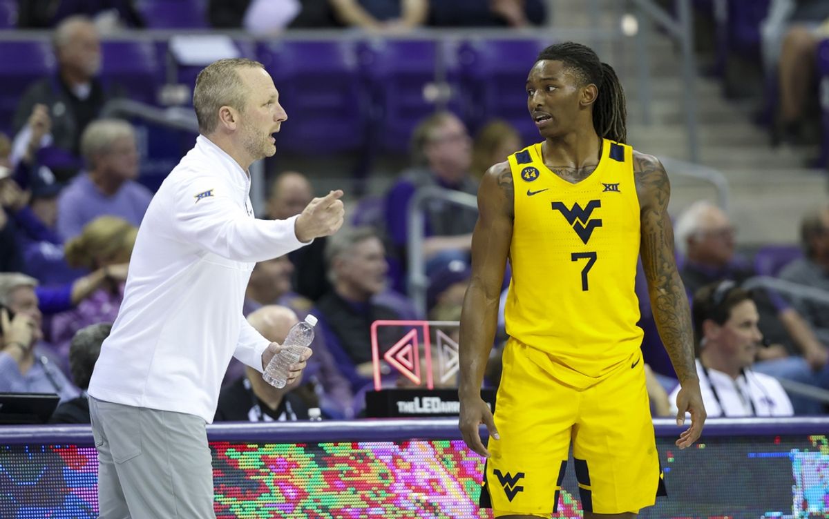 Feb 5, 2025; Fort Worth, Texas, USA;  West Virginia Mountaineers guard Javon Small (7) speaks with West Virginia Mountaineers head coach Darian DeVries during the second half against the TCU Horned Frogs at Ed and Rae Schollmaier Arena. Mandatory Credit: Kevin Jairaj-Imagn Images