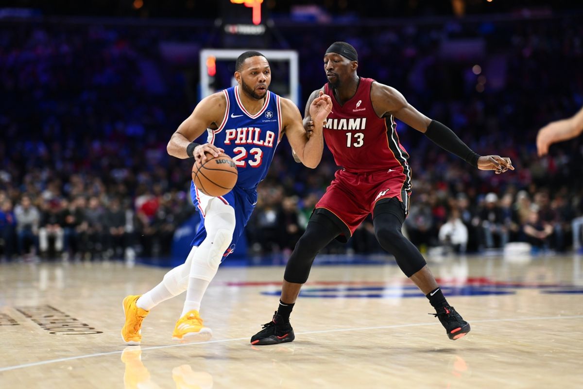 Feb 5, 2025; Philadelphia, Pennsylvania, USA; Philadelphia 76ers guard Eric Gordon (23) drives against Miami Heat center Bam Adebayo (13) in the fourth quarter at Wells Fargo Center. Mandatory Credit: Kyle Ross-Imagn Images