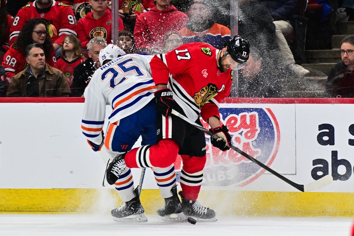 Feb 5, 2025; Chicago, Illinois, USA; Edmonton Oilers defenseman Darnell Nurse (25) and Chicago Blackhawks left wing Nick Foligno (17) battle for the puck during the first period at the United Center. Mandatory Credit: Daniel Bartel-Imagn Images