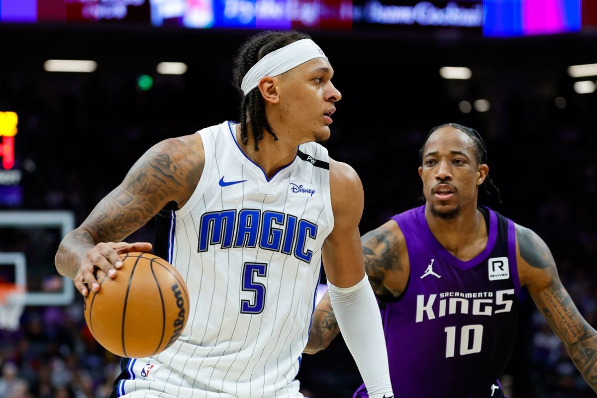 Feb 5, 2025; Sacramento, California, USA; Orlando Magic forward Paolo Banchero (5) controls the ball against Sacramento Kings forward DeMar DeRozan (10) during the second quarter at Golden 1 Center. Mandatory Credit: Sergio Estrada-Imagn Images