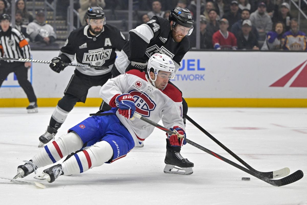Feb 5, 2025; Los Angeles, California, USA;  Montreal Canadiens center Alex Newhook (15) and Los Angeles Kings defenseman Vladislav Gavrikov (84) battle for the puck in the first period at Crypto.com Arena. Mandatory Credit: Jayne Kamin-Oncea-Imagn Images
