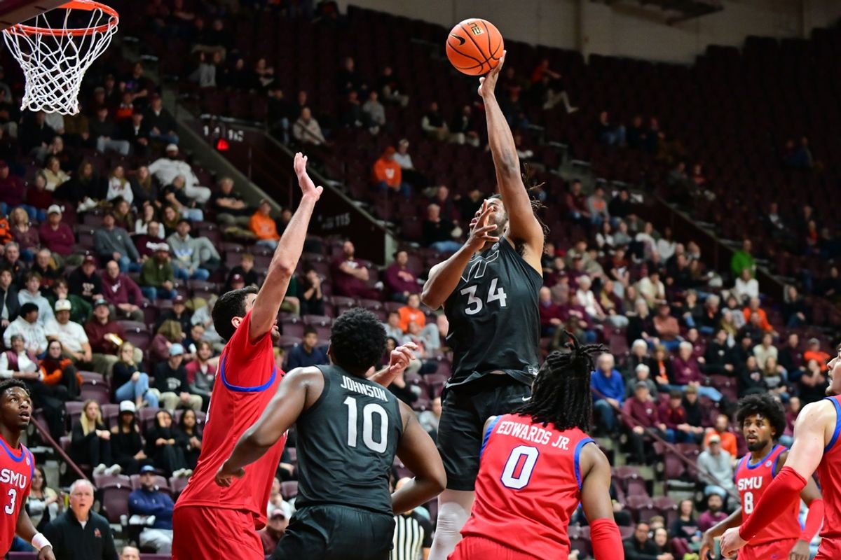 Feb 5, 2025; Blacksburg, Virginia, USA; Virginia Tech Hokies forward Mylyjael Poteat (34) shoots a shot as Southern Methodist Mustangs center Samet Yigitoglu (24) defends during the second half at Cassell Coliseum. Mandatory Credit: Brian Bishop-Imagn Images