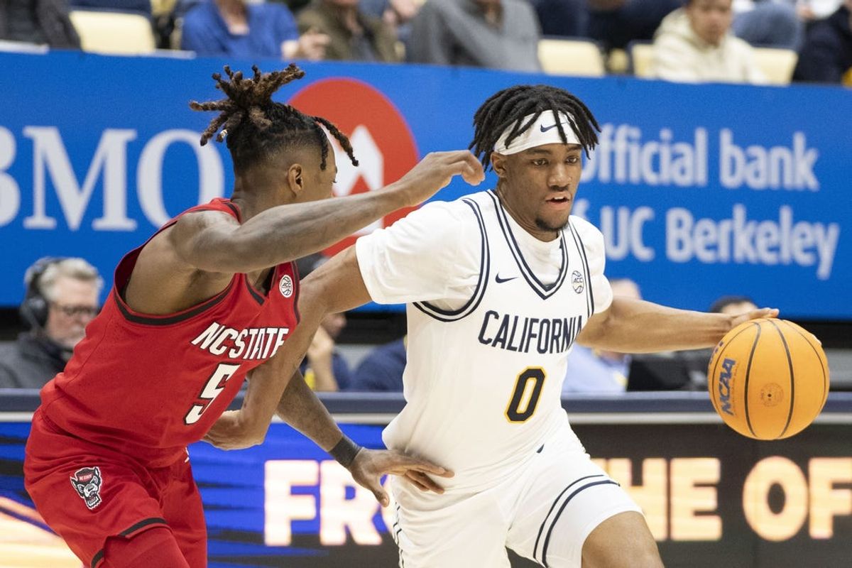 February 5, 2025; Berkeley, California, USA; California Golden Bears guard Jeremiah Wilkinson (0) dribbles the basketball against N.C. State Wolfpack guard Trey Parker (5) during the first half at Haas Pavilion. Mandatory Credit: Kyle Terada-Imagn Images