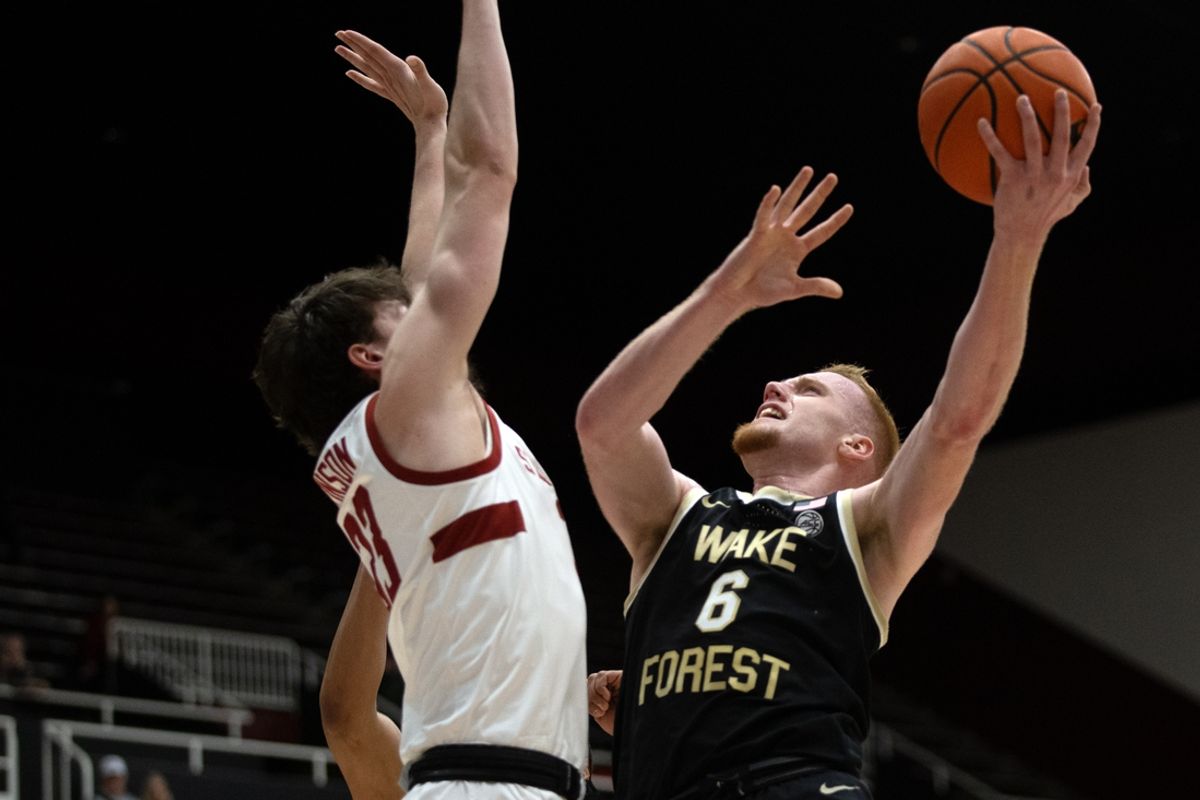 Feb 5, 2025; Stanford, California, USA; Wake Forest Demon Deacons guard Cameron Hildreth (6) goes up for a shot against Stanford Cardinal forward Evan Stinson (33) during the first half at Maples Pavilion. Mandatory Credit: D. Ross Cameron-Imagn Images