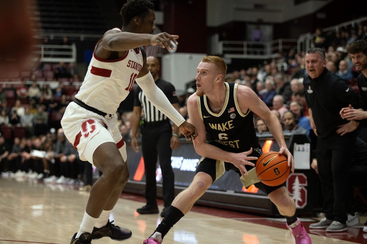 Feb 5, 2025; Stanford, California, USA; Wake Forest Demon Deacons guard Cameron Hildreth (6) steps back to shoot over Stanford Cardinal forward Chisom Okpara (10) during the first half at Maples Pavilion. Mandatory Credit: D. Ross Cameron-Imagn Images