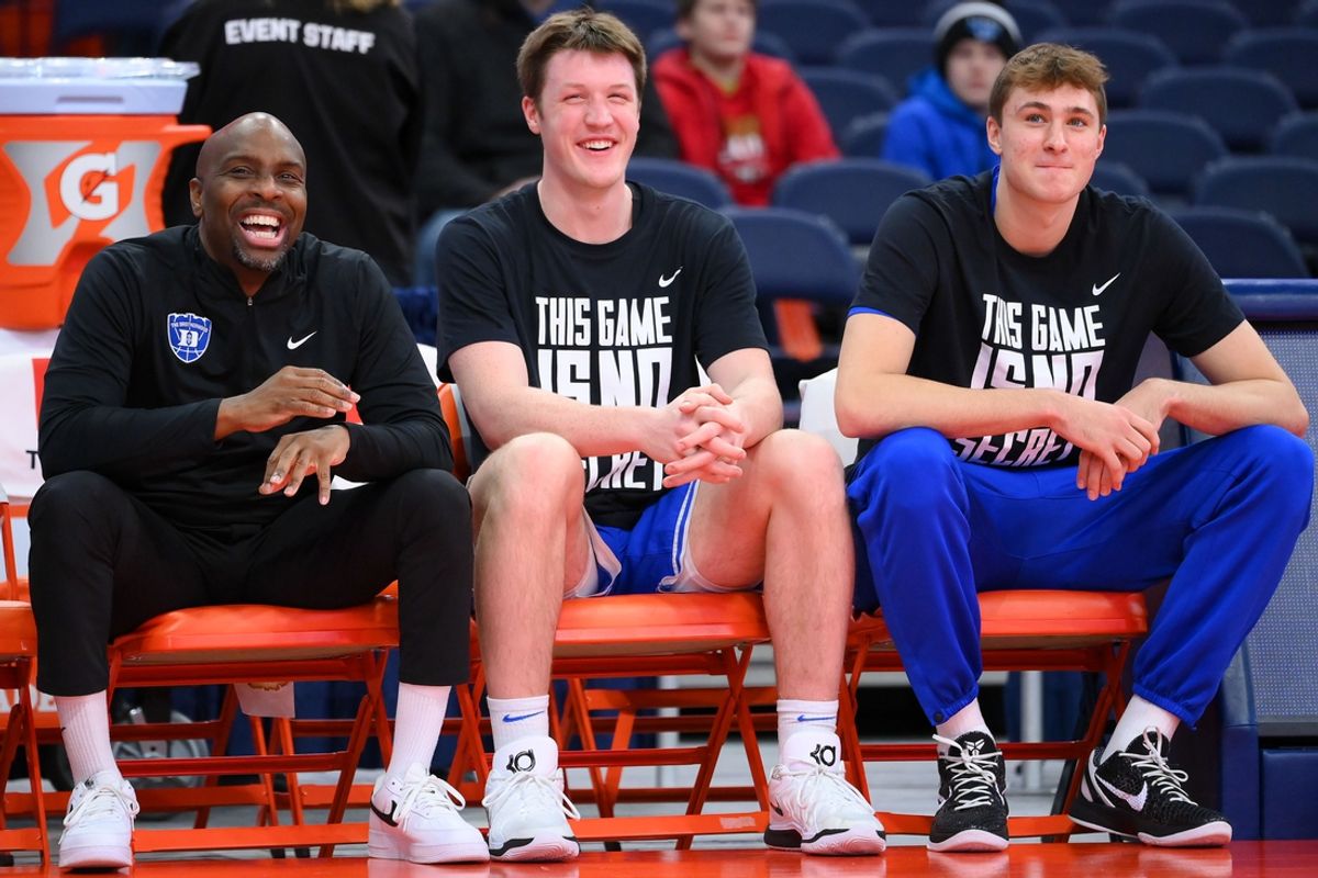 Feb 5, 2025; Syracuse, New York, USA; Duke Blue Devils assistant coach Emanuel Dildy (left) and guard Kon Knueppel (center) and guard Cooper Flagg (right) look on prior to the game against the Syracuse Orange at the JMA Wireless Dome. Mandatory Credit: Rich Barnes-Imagn Images