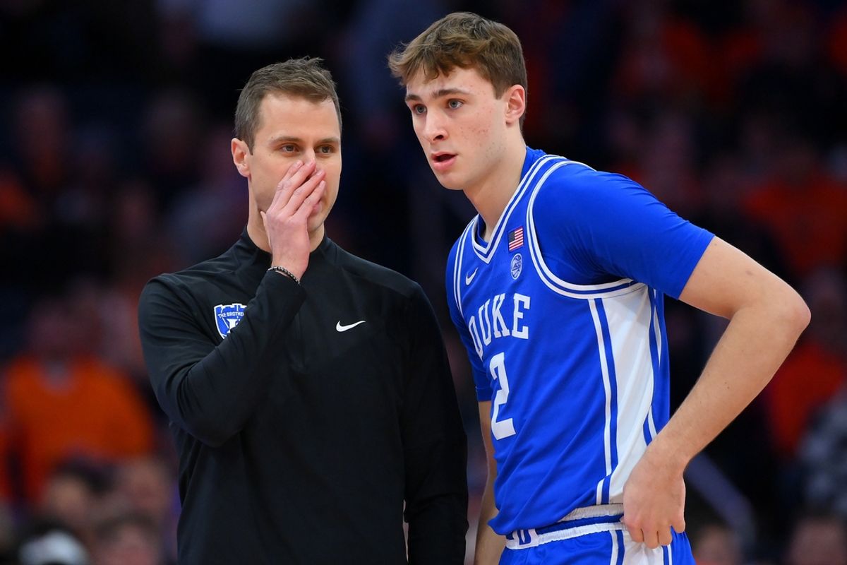Feb 5, 2025; Syracuse, New York, USA; Duke Blue Devils head coach Jon Scheyer talks with guard Cooper Flagg (2) against the Syracuse Orange during the first half at the JMA Wireless Dome. Mandatory Credit: Rich Barnes-Imagn Images