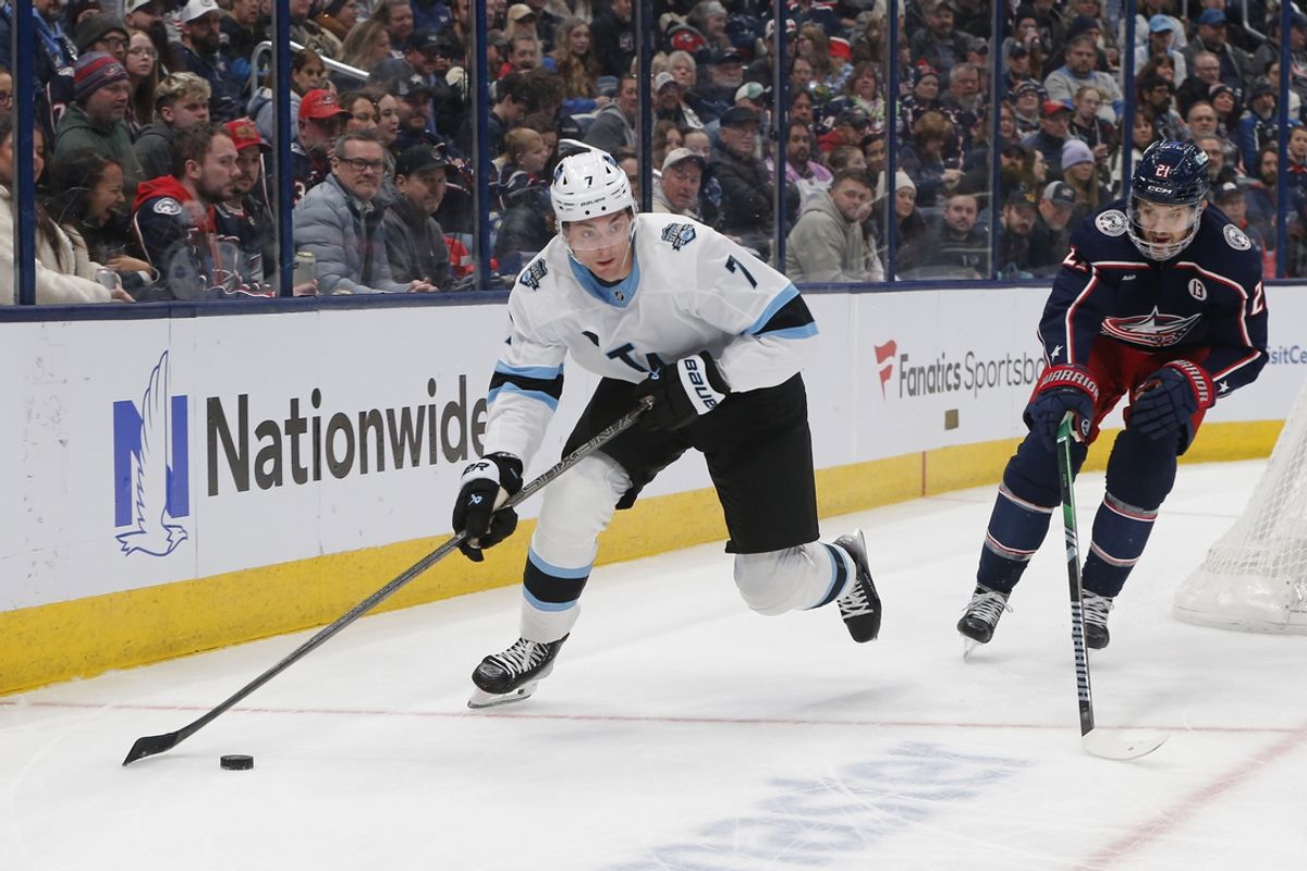 Feb 6, 2025; Columbus, Ohio, USA; Utah Hockey Club defenseman Michael Kesselring (7) looks to pass against Columbus Blue Jackets left wing James van Riemsdyk (21) during the first period at Nationwide Arena. Mandatory Credit: Russell LaBounty-Imagn Images