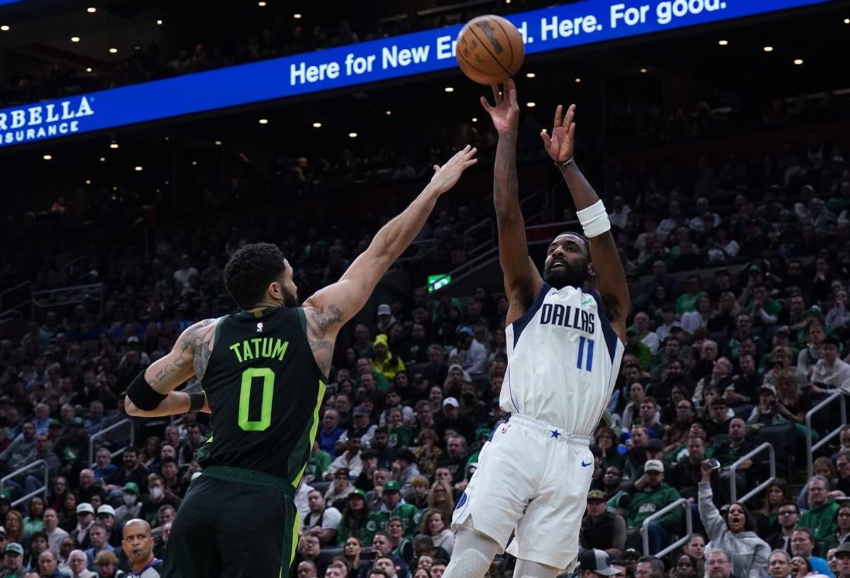 Feb 6, 2025; Boston, Massachusetts, USA; Dallas Mavericks guard Kyrie Irving (11) shoots the ball against Boston Celtics forward Jayson Tatum (0) in the second quarter at TD Garden. Mandatory Credit: David Butler II-Imagn Images