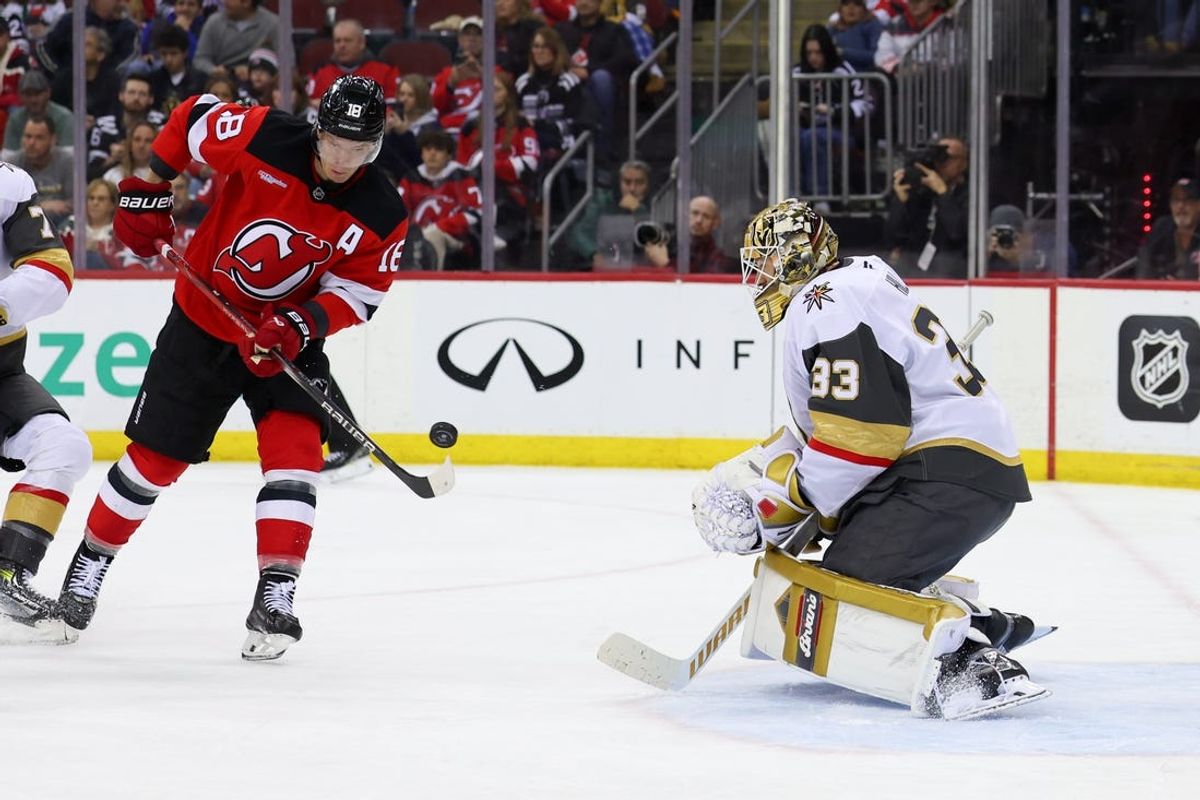 Feb 6, 2025; Newark, New Jersey, USA; New Jersey Devils left wing Ondrej Palat (18) attempts to tip the puck in front of Vegas Golden Knights goaltender Adin Hill (33) during the second period at Prudential Center. Mandatory Credit: Ed Mulholland-Imagn Images