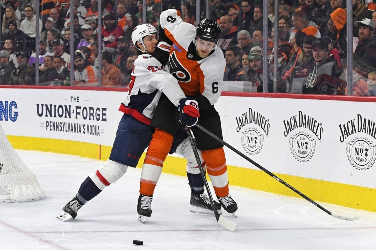 Feb 6, 2025; Philadelphia, Pennsylvania, USA; Philadelphia Flyers defenseman Travis Sanheim (6) and Washington Capitals defenseman Alexander Alexeyev (27) battle for the puck during the second period at Wells Fargo Center. Mandatory Credit: Eric Hartline-Imagn Images
