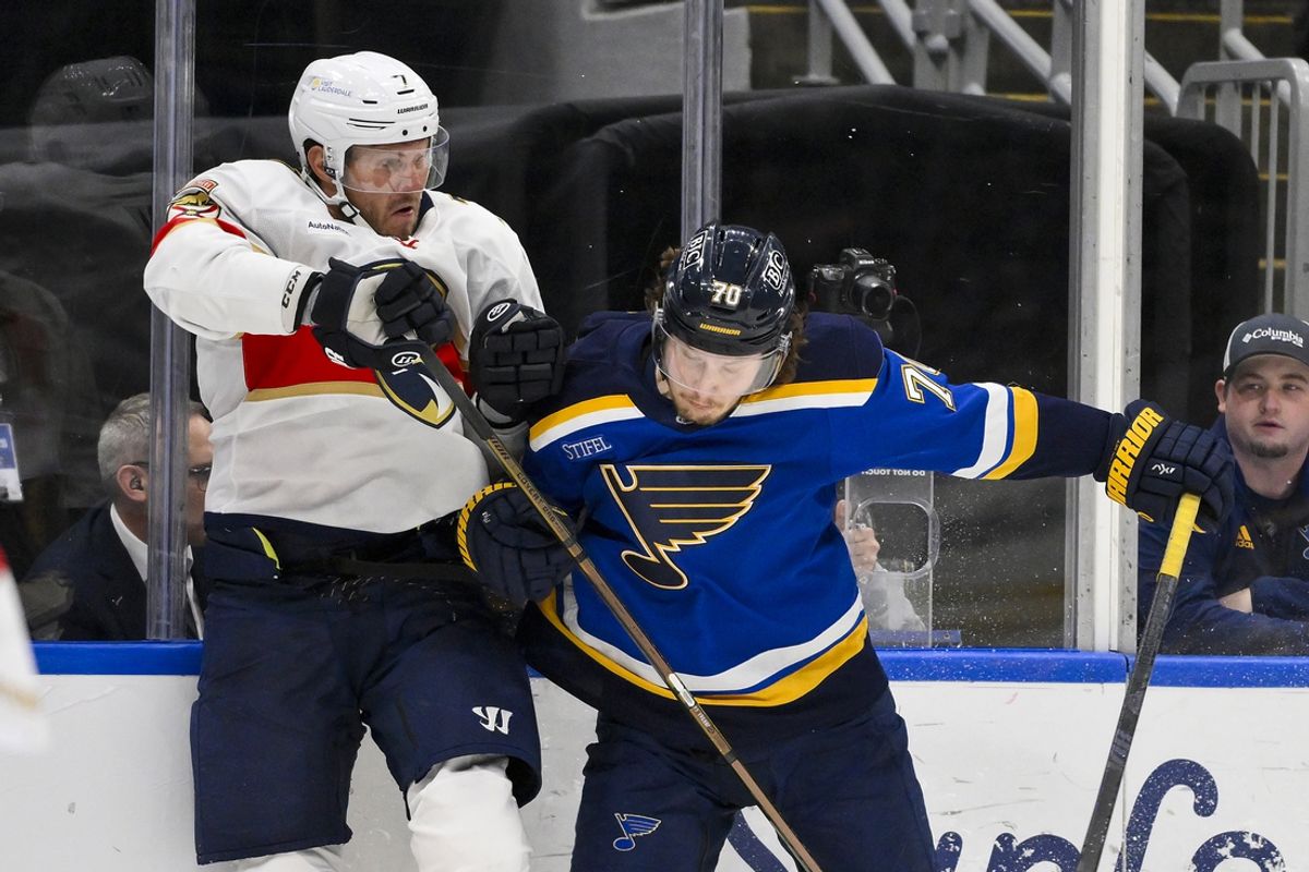 Feb 6, 2025; St. Louis, Missouri, USA;  St. Louis Blues center Oskar Sundqvist (70) checks Florida Panthers defenseman Dmitry Kulikov (7) during the second period at Enterprise Center. Mandatory Credit: Jeff Curry-Imagn Images