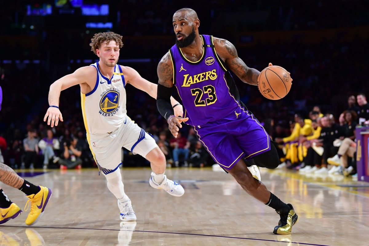 Feb 6, 2025; Los Angeles, California, USA; Los Angeles Lakers forward LeBron James (23) moves to the basket against Golden State Warriors guard Brandin Podziemski (2) during the first half at Crypto.com Arena. Mandatory Credit: Gary A. Vasquez-Imagn Images