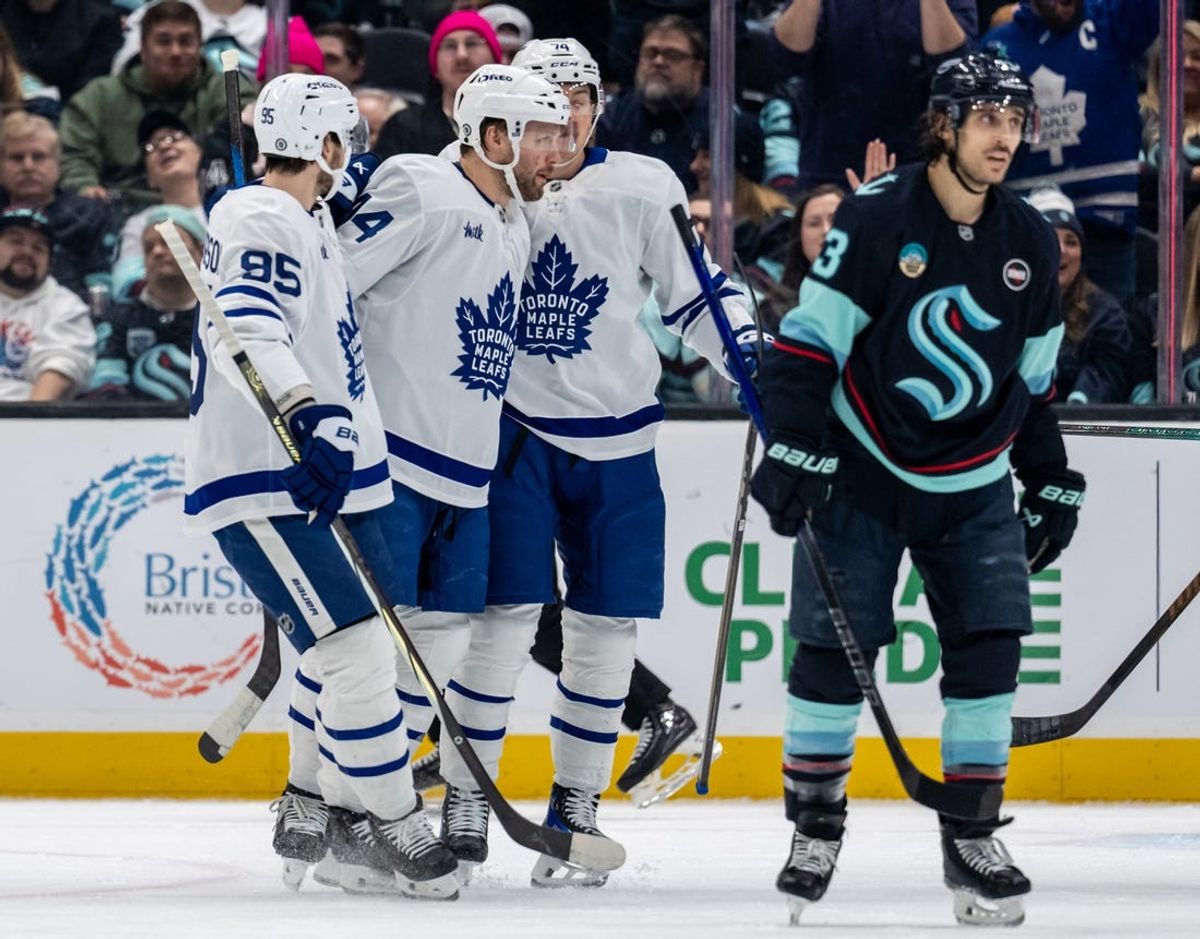 Feb 6, 2025; Seattle, Washington, USA;  Toronto Maple Leafs, from left, defenseman Oliver Ekman-Larsson (95), defenseman Morgan Rielly (44) and forward Bobby McMann (74) celebrate a goal in front of  forward Brandon Tanev (13) during the first period at Climate Pledge Arena. Mandatory Credit: Stephen Brashear-Imagn Images