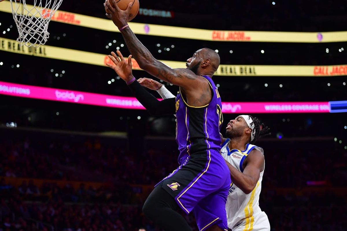Feb 6, 2025; Los Angeles, California, USA; Los Angeles Lakers forward LeBron James (23) moves to the basket against Golden State Warriors guard Buddy Hield (7) during the first half at Crypto.com Arena. Mandatory Credit: Gary A. Vasquez-Imagn Images