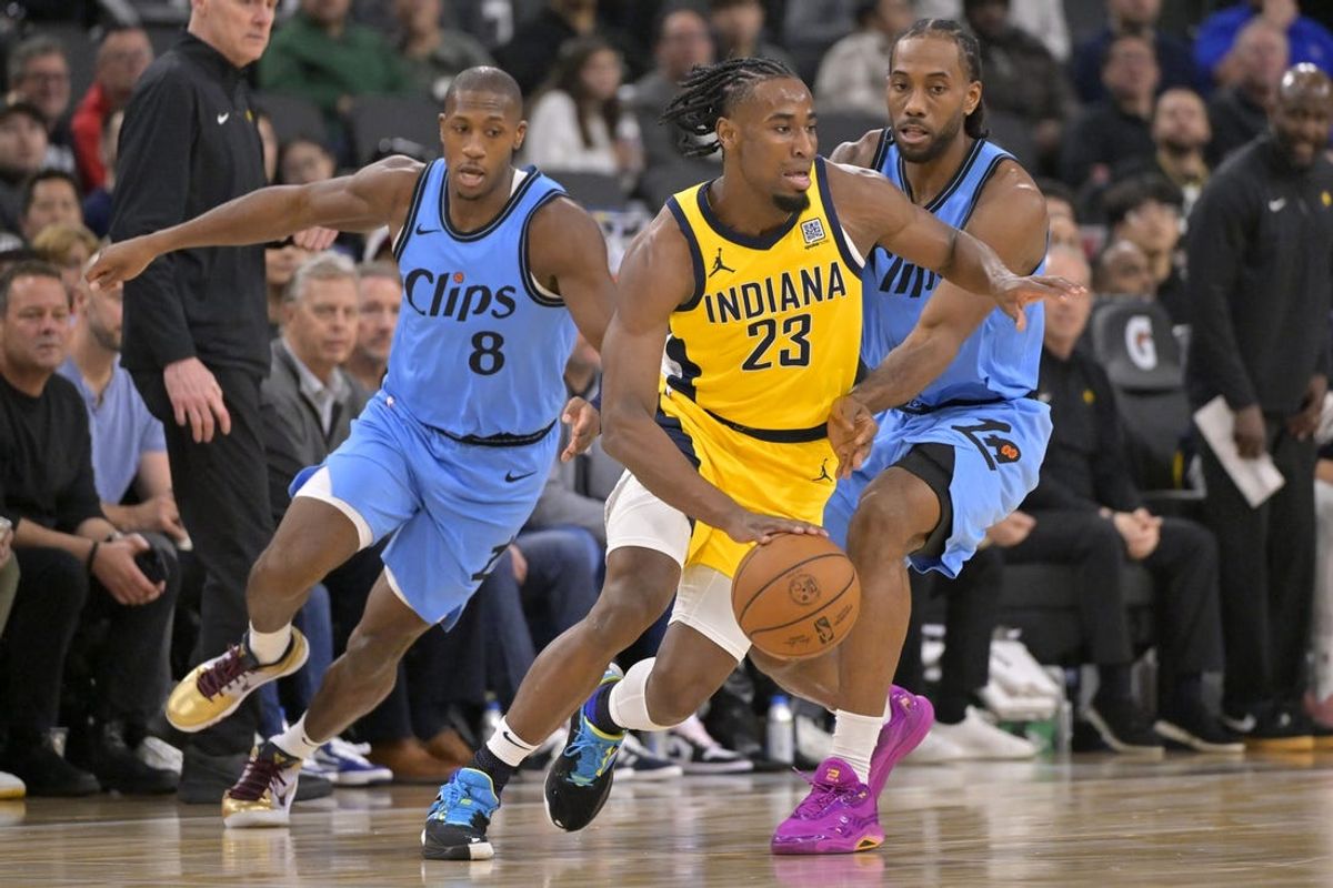 Feb 6, 2025; Inglewood, California, USA;  Indiana Pacers forward Aaron Nesmith (23) controls the ball in front of Los Angeles Clippers guard Kris Dunn (8) and forward Kawhi Leonard (2) in the first half at Intuit Dome. Mandatory Credit: Jayne Kamin-Oncea-Imagn Images