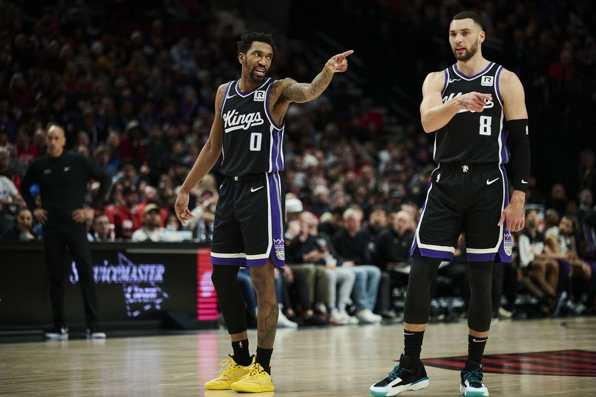 Feb 6, 2025; Portland, Oregon, USA; Sacramento Kings guard Malik Monk (0) and guard Zach LaVine (8) talk during a break in the action against the Portland Trail Blazers at Moda Center. Mandatory Credit: Troy Wayrynen-Imagn Images