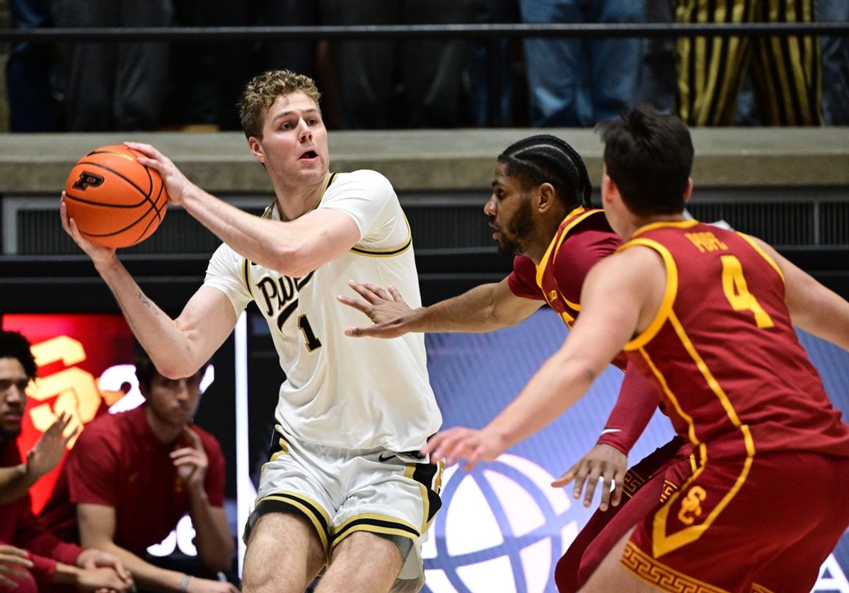 Feb 7, 2025; West Lafayette, Indiana, USA; Purdue Boilermakers forward Caleb Furst (1) looks for a teammate around USC Trojans guard Bryce Pope (4) during the first half at Mackey Arena. Mandatory Credit: Marc Lebryk-Imagn Images
