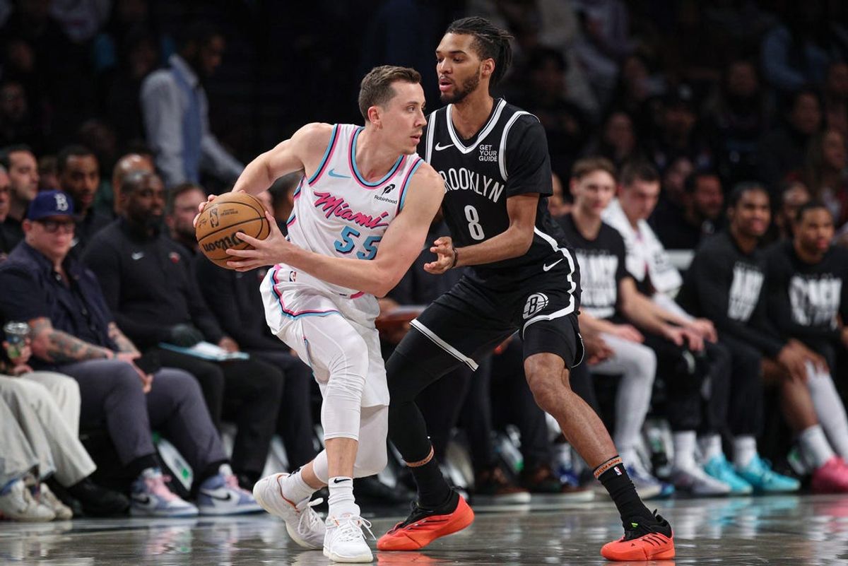 Feb 7, 2025; Brooklyn, New York, USA; Miami Heat forward Duncan Robinson (55) is guarded by Brooklyn Nets forward Ziaire Williams (8) during the first half at Barclays Center. Mandatory Credit: Vincent Carchietta-Imagn Images