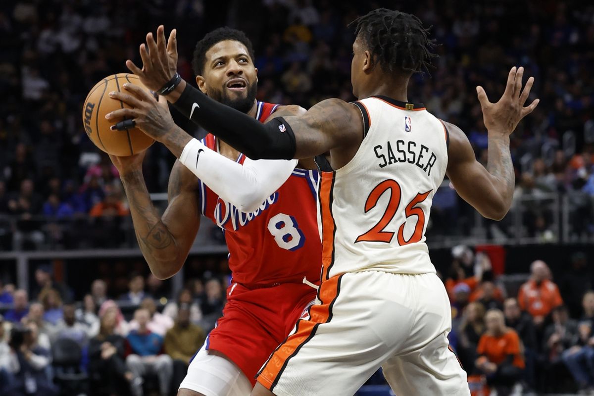 Feb 7, 2025; Detroit, Michigan, USA;  Philadelphia 76ers forward Paul George (8) is defended by Detroit Pistons guard Marcus Sasser (25) in the first half at Little Caesars Arena. Mandatory Credit: Rick Osentoski-Imagn Images