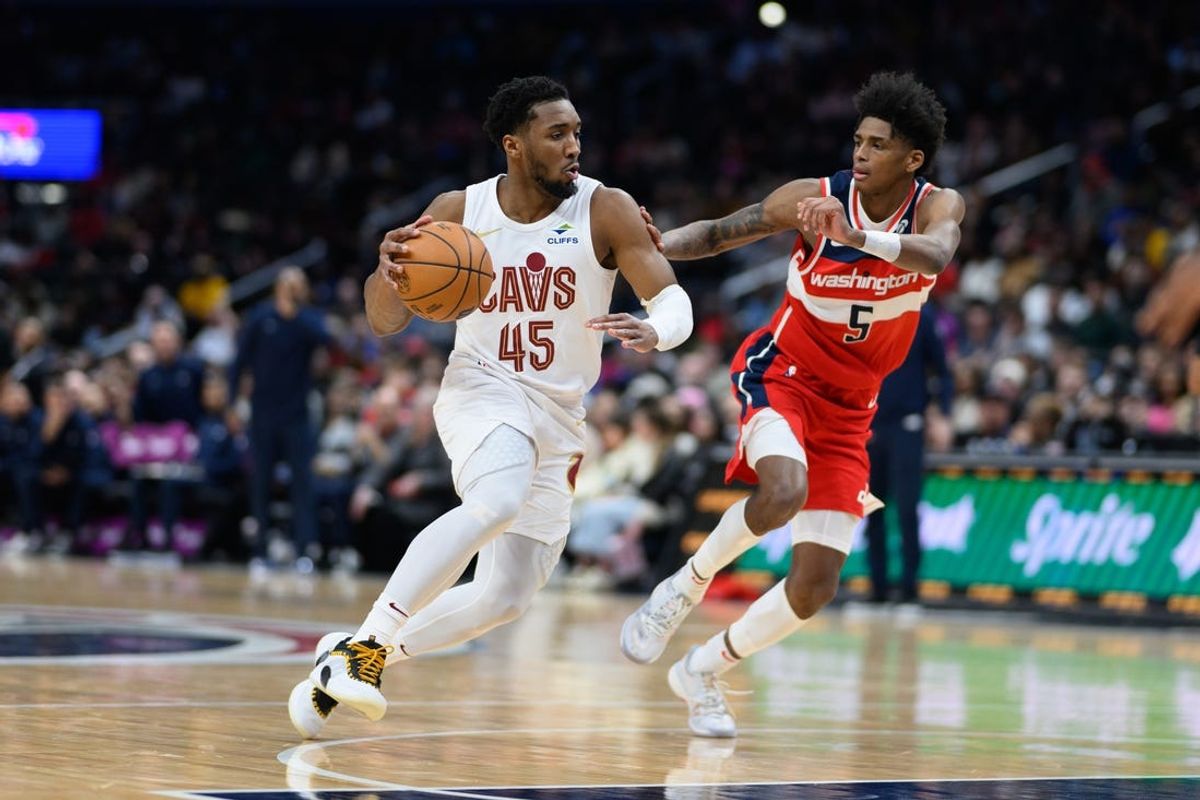 Feb 7, 2025; Washington, District of Columbia, USA; Cleveland Cavaliers guard Donovan Mitchell (45) handles the ball against Washington Wizards guard AJ Johnson (5) during the fourth quarter at Capital One Arena. Mandatory Credit: Reggie Hildred-Imagn Images