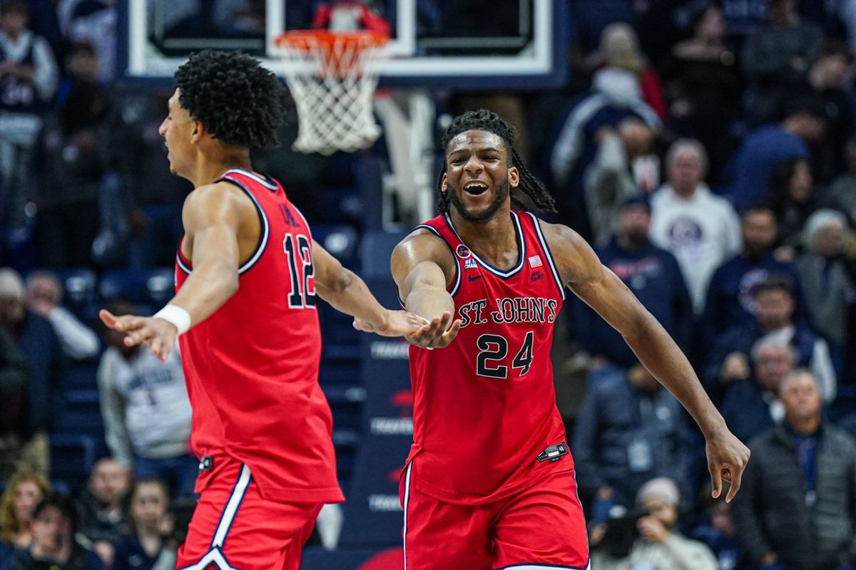 Feb 7, 2025; Storrs, Connecticut, USA;St. St. John's Red Storm forward Zuby Ejiofor (24) and guard RJ Luis Jr. (12) react after defeating the UConn Huskies in the second half at Harry A. Gampel Pavilion. Mandatory Credit: David Butler II-Imagn Images