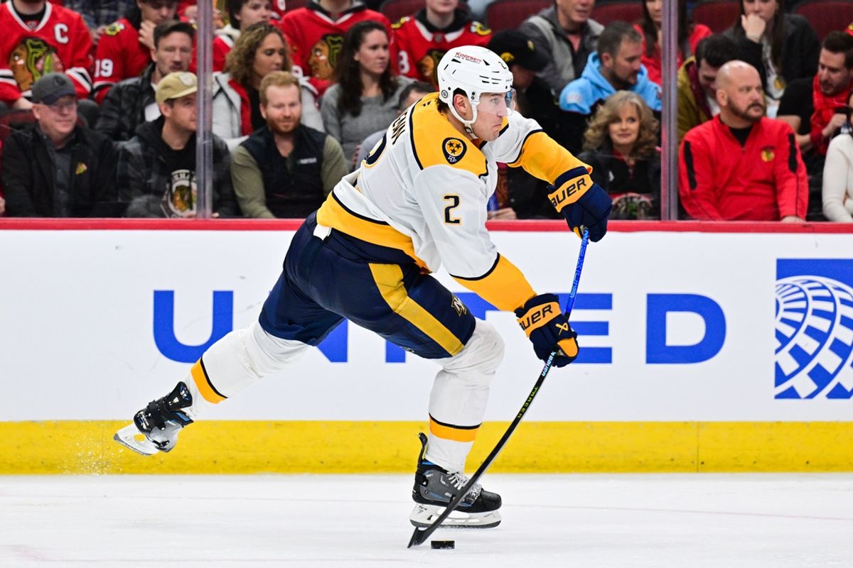 Feb 7, 2025; Chicago, Illinois, USA; Nashville Predators defenseman Luke Schenn (2) passes the puck against the Chicago Blackhawks during the third period at the United Center. Mandatory Credit: Daniel Bartel-Imagn Images