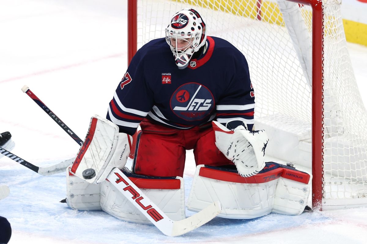Feb 7, 2025; Winnipeg, Manitoba, CAN; Winnipeg Jets goaltender Connor Hellebuyck (37) makes a blocker save against the New York Islanders in the third period at Canada Life Centre. Mandatory Credit: James Carey Lauder-Imagn Images