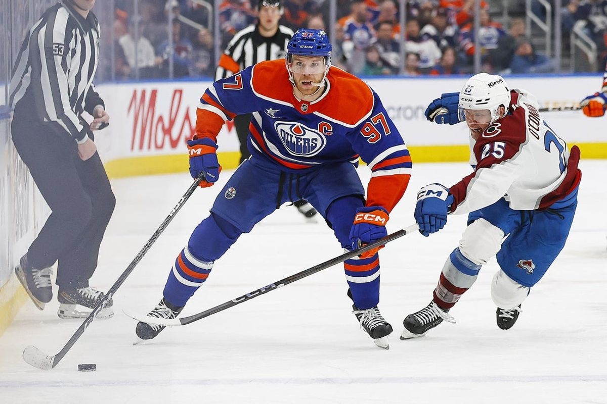 Feb 7, 2025; Edmonton, Alberta, CAN; Edmonton Oilers forward Connor McDavid (97) carries the puck around Colorado Avalanche forward Logan O’Connor (25) during the third period at Rogers Place. Mandatory Credit: Perry Nelson-Imagn Images
