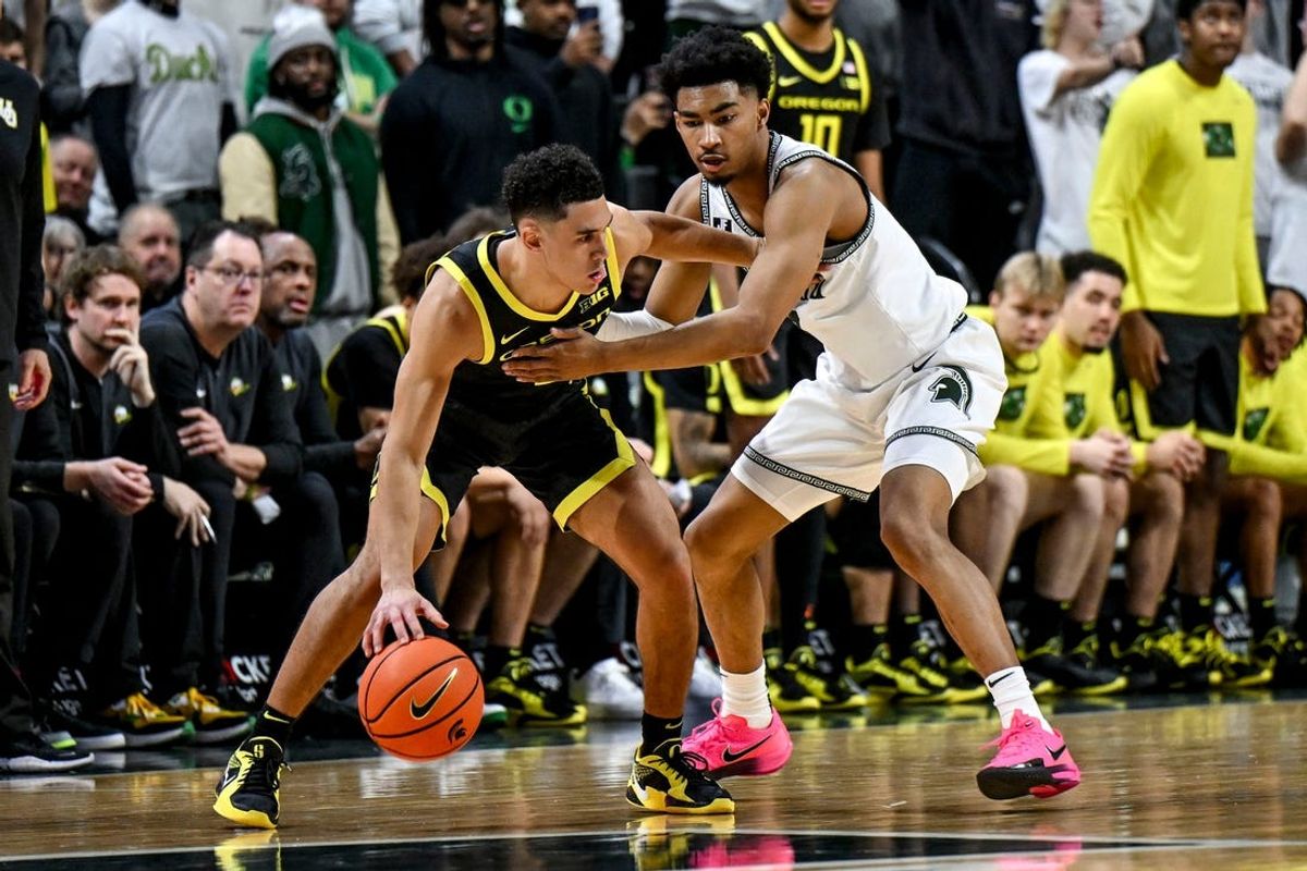 Michigan State's Jaden Akins, right, guards Oregon's Jackson Shelstad during the second half on Saturday, Feb. 8, 2025, at the Breslin Center East Lansing.