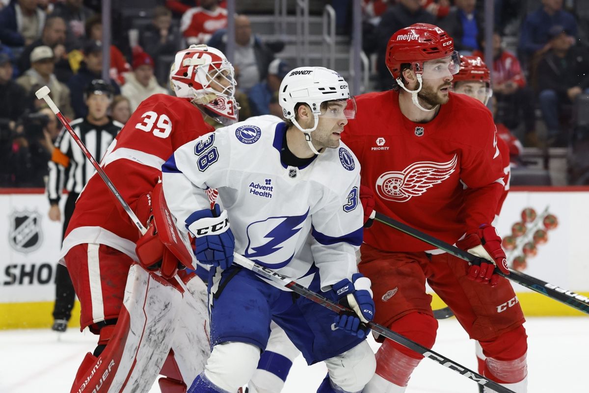 Feb 8, 2025; Detroit, Michigan, USA;  Tampa Bay Lightning left wing Brandon Hagel (38) and Detroit Red Wings center Michael Rasmussen (27) fight for position in front of goaltender Cam Talbot (39) in the first period at Little Caesars Arena. Mandatory Credit: Rick Osentoski-Imagn Images