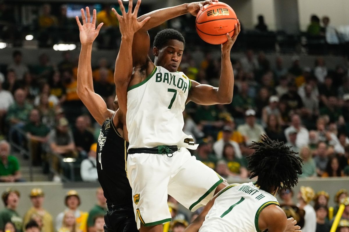 Feb 8, 2025; Waco, Texas, USA; Baylor Bears guard VJ Edgecombe (7) grabs a rebound against UCF Knights guard Keyshawn Hall (4) during the first half at Paul and Alejandra Foster Pavilion. Mandatory Credit: Chris Jones-Imagn Images