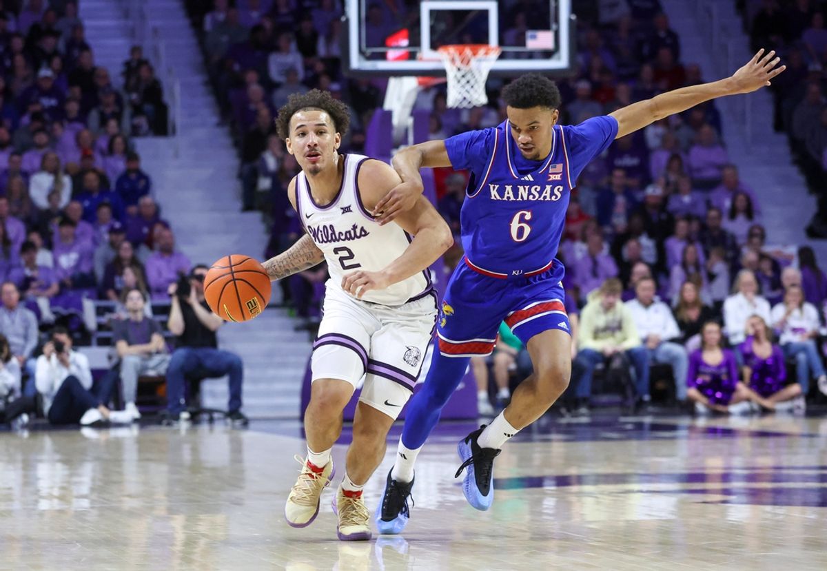 Feb 8, 2025; Manhattan, Kansas, USA; Kansas State Wildcats guard Max Jones (2) dribbles by Kansas Jayhawks guard Rylan Griffen (6) during the first half at Bramlage Coliseum. Mandatory Credit: Scott Sewell-Imagn Images